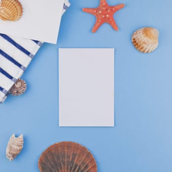 Creative square flat lay concept of summer travel vacations. Top view of beach towel and seashells and starfish on pastel blue background with copy space in minimal style, template for text