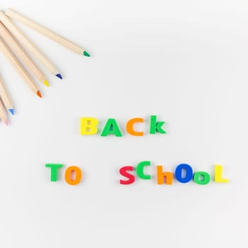 Square flat lay back to school concept with color school and office supplies on white table background with copy space, frame, template for text or design