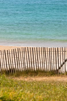 Wooden fence at northern beach in France. Vertical shot