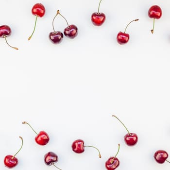 Square top view of fresh ripe cherry pattern layout with copy space isolated on white background in minimal style. Concept of summer fun and healthy eating. Template for your text or food design