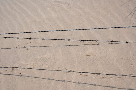 Barbed wire fence in the sand dunes
