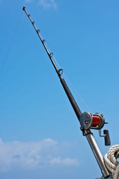Fishing rod and reel on a sailing yacht. Vertical shot