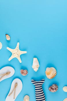 Creative flat lay concept of summer travel vacations. Top view of seashells and starfish on turquoise blue background with postcard mock up and copy space in minimal style, template for text