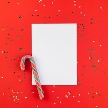 Creative New Year or Christmas greetings letter mockup flat lay top view Xmas holiday celebration envelope on red paper background golden glitter. Square Template mock up greeting card text 2019 2020
