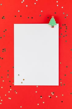 Creative New Year or Christmas greetings letter mockup flat lay top view Xmas holiday celebration envelope on red paper background golden glitter. Template mock up greeting card text design 2019 2020