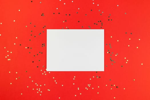 Creative New Year or Christmas greetings letter mockup flat lay top view Xmas holiday celebration envelope on red paper background golden glitter. Template mock up greeting card text design 2019 2020