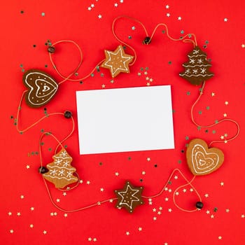 Creative New Year or Christmas greetings letter mockup flat lay top view Xmas holiday celebration envelope on red paper background golden glitter. Square Template mock up greeting card text 2019 2020