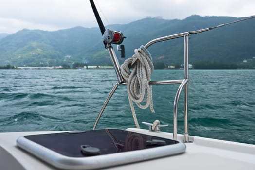 Fishing rod and reel on a sailing yacht. Horizontal shot