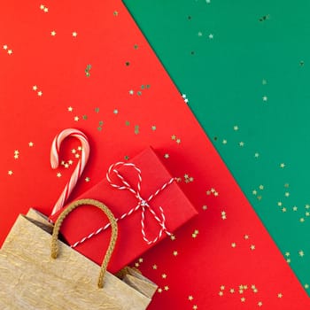 New Year or Christmas presents preparation DIY flat lay top view Xmas holiday celebration handmade gift boxes on red green paper background. Template mockup for greeting card or your text design 2019