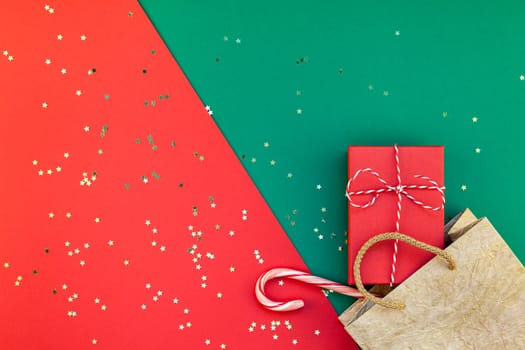 New Year or Christmas presents preparation DIY flat lay top view Xmas holiday celebration handmade gift boxes on red green paper background. Template mockup for greeting card or your text design 2019
