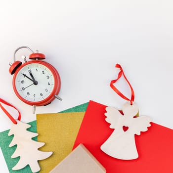 New Year or Christmas decoration presents making flat lay top view Xmas holiday celebration preparation DIY concept decor on white natural light background. Square Template greeting card your design