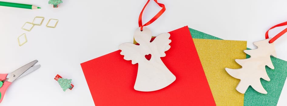 New Year or Christmas decoration presents making flat lay top view Xmas holiday celebration preparation DIY concept decor on white natural light background. Template long wide banner
