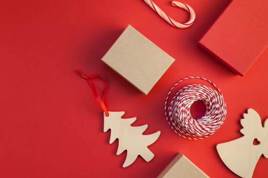 New Year or Christmas presents wrapped with ribbon flat lay top view Xmas holiday 2019 celebration handmade gift boxes on red paper background copyspace. Template mockup greeting card your text design