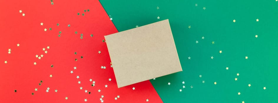 New Year or Christmas presents preparation DIY flat lay top view Xmas holiday celebration handmade gift boxes on red green paper background. Template mockup for greeting card long wide banner 2019