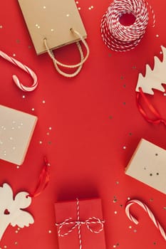 New Year Christmas presents wrapped ribbon flat lay top view Xmas 2019 holiday celebration handmade gift boxes red paper golden sparkles background copyspace. Template mockup greeting card text design