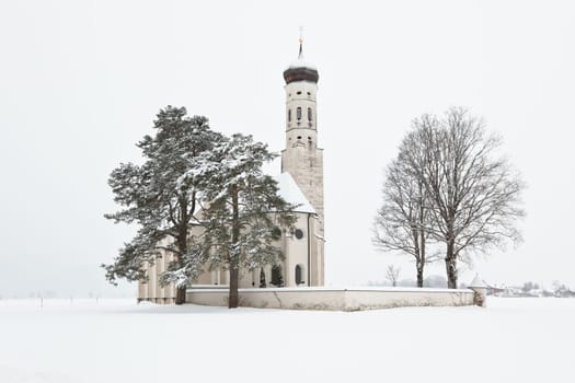 Beautiful Alpine bavarian Church after morning snowfall in mountain village