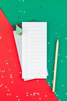 Creative New Year or Christmas todo list event planner mockup flat lay top view Xmas holiday celebration holiday schedule check list on red green paper background. To do Template mock up 2019 2020