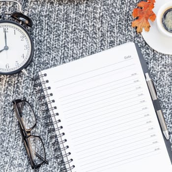 Creative square autumn flat lay overhead top view stylish home workspace planner organizer coffee cup cozy gray knitted plaid background copy space. Fall season template for feminine blog social media