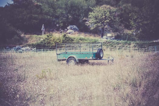 Old cargo trailer in a rural place. Vintage filtered shot