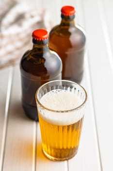 Glass of beer on a white table.