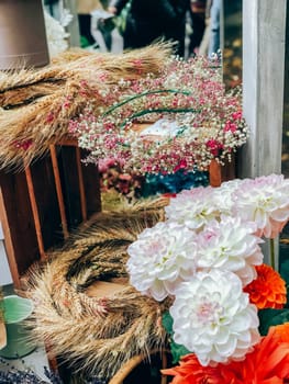 Beautiful dahlias flowers bouquet in small florist shop. Modern style flowers arrangement in lifestyle natural light composition. Small business