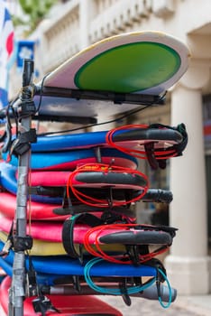 set of different color surf boards in a stack. France