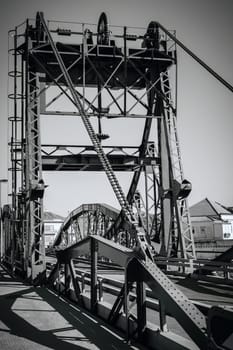 Metal structure elevation bridge over Sado river. Alcacer do Sal, Portugal. BW filtered shot
