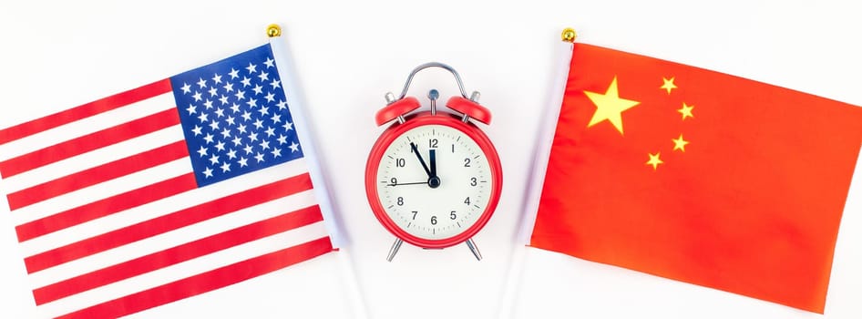 Creative top view flat lay of China and USA flag red alarm clock and copy space white background in minimal style. Concept of trade war between USA and China