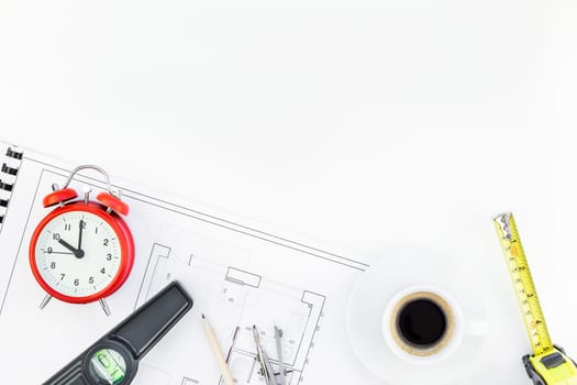 Creative flat lay overhead top view blueprint flat project plan hot coffee cup alarm clock and office supplies on decorator table workspace swatches tools and equipment background copy space concept