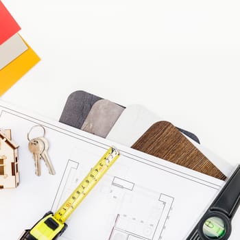 Creative flat lay overhead top view blueprint flat project plan and office supplies on decorator table workspace swatches tools and equipment background copy space concept