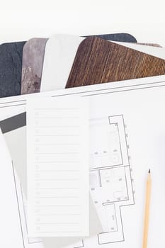 Creative flat lay overhead top view blueprint flat project plan and office supplies on decorator table workspace swatches tools and equipment background copy space concept