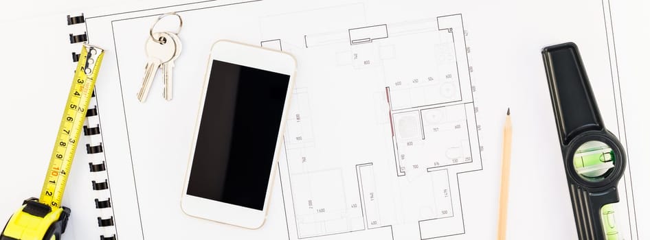 Creative flat lay overhead top view blueprint flat project plan and mobile smartphone office supplies on decorator table workspace swatches tools and equipment background copy space concept