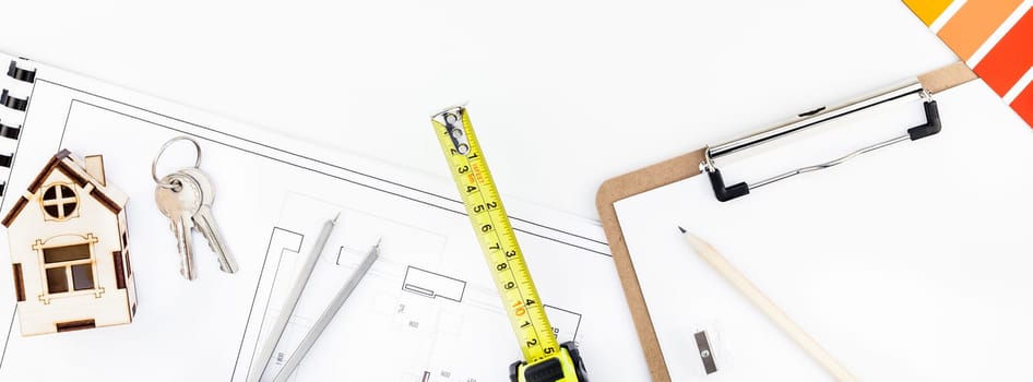Creative flat lay overhead top view blueprint flat project plan and office supplies on decorator table workspace swatches tools and equipment background copy space concept