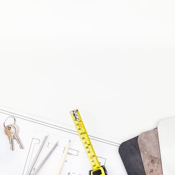 Creative flat lay overhead top view blueprint flat project plan and office supplies on decorator table workspace swatches tools and equipment background copy space concept