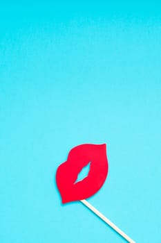 Creative overhead top view retro stylish red paper photo booth props female lips turquoise background copy space. Birthday parties and weddings valentine day template