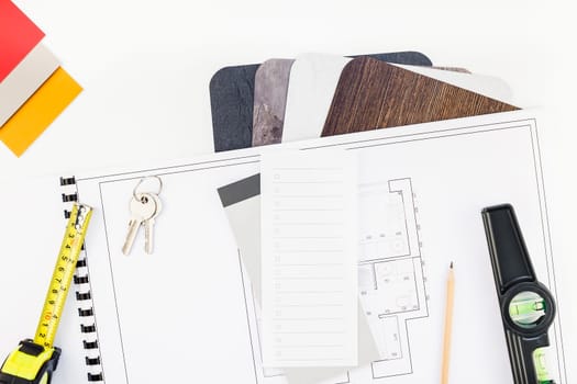 Creative flat lay overhead top view blueprint flat project plan and office supplies on decorator table workspace swatches tools and equipment background copy space concept
