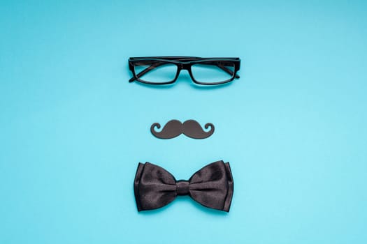 Creative flatlay overhead top view retro stylish black paper photo booth props moustaches turquoise background copy space. Men health awareness month fathers day masculinity concept blog social media