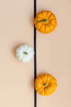 Creative Top view flat lay autumn composition. Frame concept pumpkins color paper background copy space. Template fall harvest thanksgiving halloween anniversary invitation cards