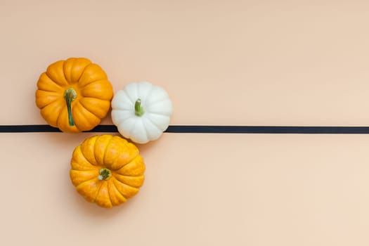 Creative Top view flat lay autumn composition. Frame concept pumpkins color paper background copy space. Template fall harvest thanksgiving halloween anniversary invitation cards