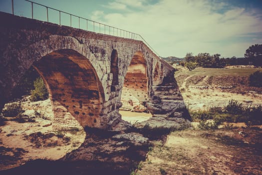 Old roman bridge Julien pont in Provence, France. Filtered shot