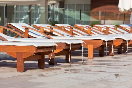 Hotel Wooden Poolside Chairs. Horizontal shot