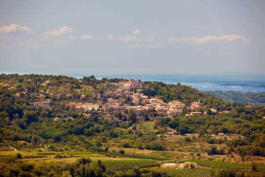 Landscape with a Castle ruins on a hill above the village in Provence, Southern France