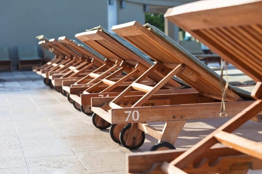 Hotel Wooden Poolside Chairs Detail Close Up. Horizontal shot