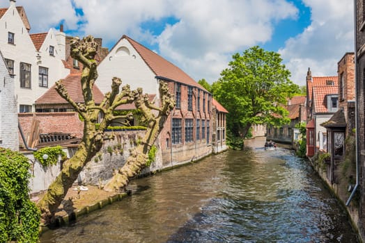 Boat full of tourist enjoying a beautiful canal in Bruges Belgium