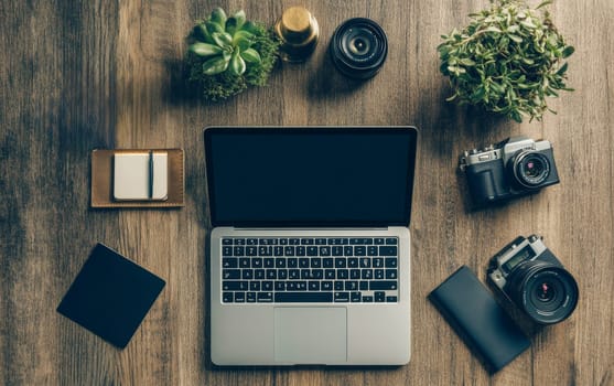 Organized desk setup featuring laptop, cameras, and plants on wooden surface, representing a contemporary creative professional's workspace with technology and nature elements.