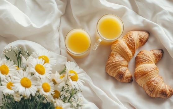 Delightful breakfast scene with croissants, orange juice, and fresh daisies on white bedding, embodying a serene morning indulgence.