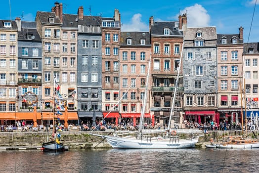 FRANCE, HONFLEUR - MAY 30: Honfleur harbour in Normandy, France. Color houses and their reflection in water on May 30, 2015