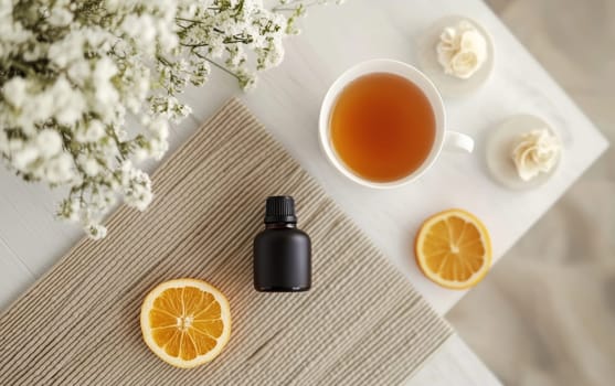 Calming tea scene with cup of herbal tea, essential oil bottle, lemon slices, and delicate white flowers on textured background, perfect for relaxation.