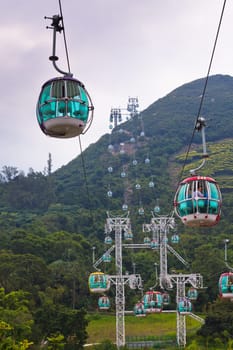 HONG KONG, HONG KONG - OCTOBER 01: cable cars over tropical trees in Hong Kong on October 01, 2012