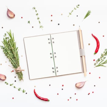 Flat lay overhead view blank notebook pages mockup text space invitation card on white background with greens herbs and spices. Menu or recipe book or food blog design with cooking ingredients